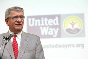 Paul Logli in from of United Way logo