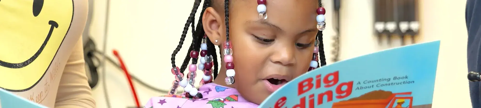 young girl reading in doctor's office