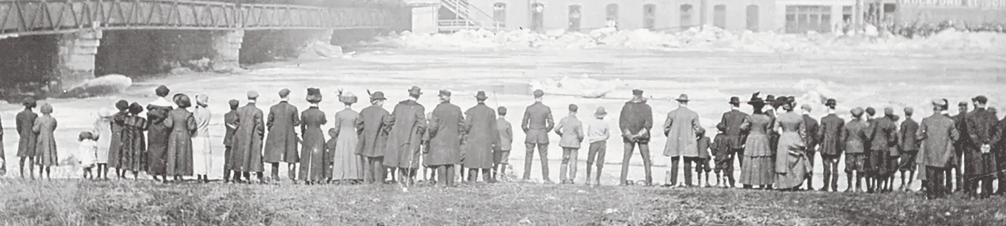 black and white photo of people down by the rock river