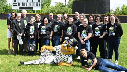 United Way staff and board with Rally, the Rivets mascot