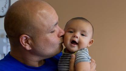 Father kissing baby
