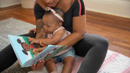 baby and mom with book
